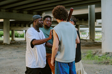 Two street bands arguing while standing under huge bridge