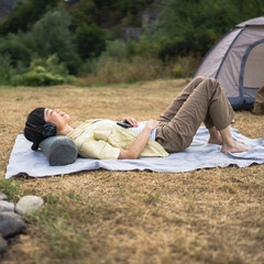 Japanese woman practice guided meditation manifestation in front tent