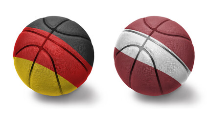 basketball balls with the national flags of latvia and germany on the white background.