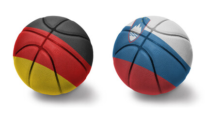 Obraz premium basketball balls with the national flags of slovenia and germany on the white background.