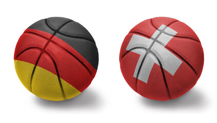 Obraz premium basketball balls with the national flags of switzerland and germany on the white background.