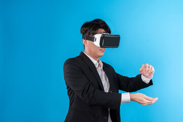 Asian businessman looking thorough VR try to zoom in or out with connecting business world report in futuristic metaverse analyzing innovation technology virtual reality blue copyspace. Contrivance.