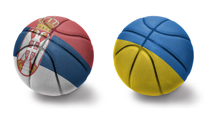 basketball balls with the national flags of ukraine and serbia on the white background.