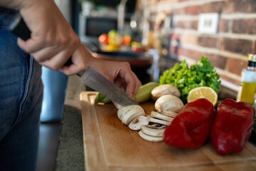 Young woman preparing fresh vegetables in a modern kitchen