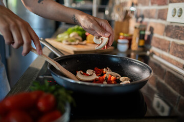 Young woman preparing fresh vegetables in a modern kitchen