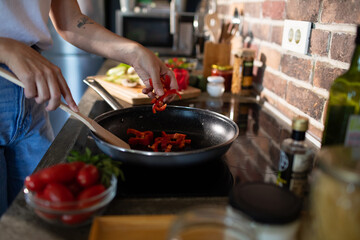 Young woman preparing fresh vegetables in a modern kitchen