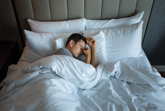 Exhausted man can't sleep, people having trouble sleeping waking up tired 