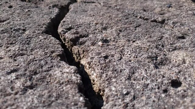 Crack in the stone. A crack, crevice in concrete stone, concrete surface. Authentic damaged concrete slab, crack in foundation,concrete.