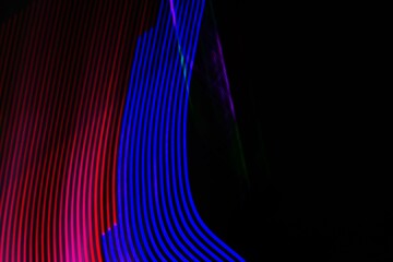A colorful, abstract image with a blue and red stripe. The image is a representation of a wave,...