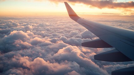Obraz premium Through an airplane window, a breathtaking panorama unfolds: a tapestry of clouds billowing softly below, their ethereal forms casting an enchanting spell.