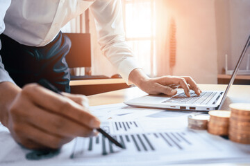 Businessman accountant or financial expert analyze business report graph and finance chart at corporate office. Concept of finance economy, banking business and stock market research. uds