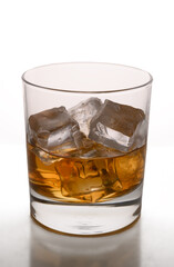 Glass of whiskey with ice cubes