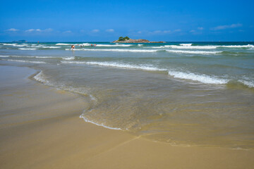 Beautiful blue sky morning at Pitangueiras beach. Beach on downtown of Guaruja, SP, Brazil.