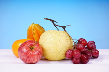 still life with apples, oranges, grapes and starfruit