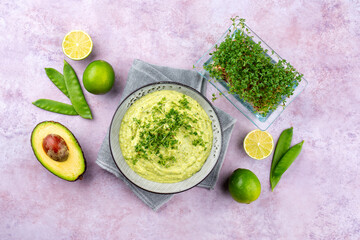 Traditional exotic spring dip with avocado and roasted vegetables served as top view in a Nordic design bowl