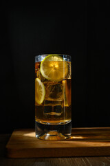 Glass of iced tea with lemon and ice cubes, isolated