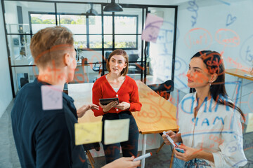 Naklejka premium Creative business team brainstorming discussing and sharing marketing idea about start up project by using mind map colorful sticky note at glass board meeting room. Working together. Immaculate.