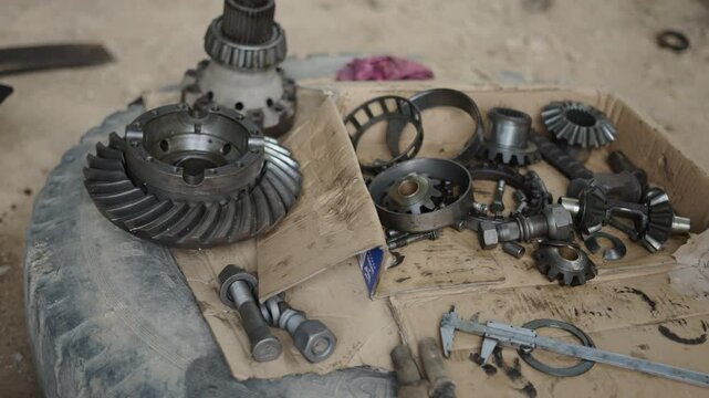 close-up satellite and planetary gears of a disassembled differential of a large truck in a workshop