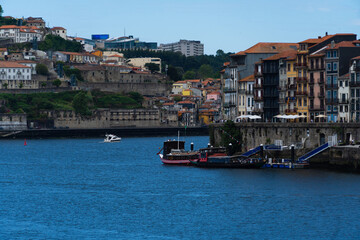Obraz premium View of Porto city and Douro river and Dom Luis bridge. Porto, Vila Nova de Gaia, Portugal. Cityscape along the river