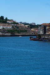 View of Porto city and Douro river and Dom Luis bridge. Porto, Vila Nova de Gaia, Portugal. Cityscape along the river