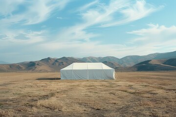 A white tent sits amidst hills