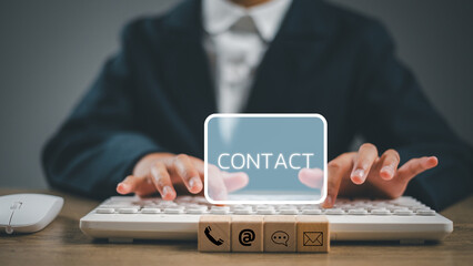 Website page contact us or e-mail marketing concept, Customer support hotline Contact us people connection. cube wood with the email, call phone, address, Chat message icons. on keyboard computer.