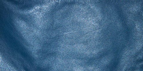 Blue natural dyed leather with seams as a background. A piece of leather clothing.