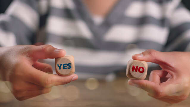 Think With Yes Or No Choice, Business Choices For Difficult Situations, Yes or no and question mark, man holding two wooden with yes or no word on it, making decision.