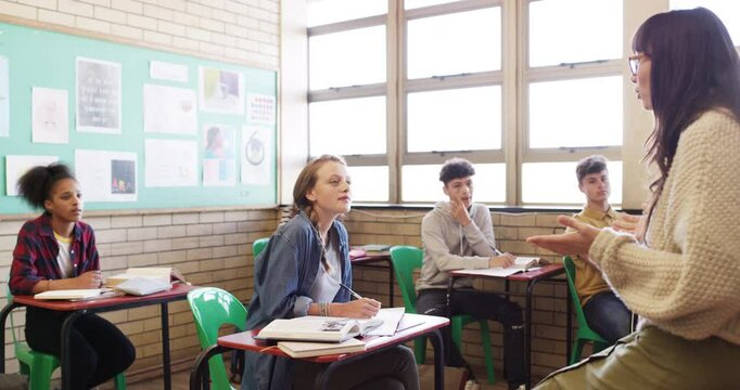 Student, teacher and raise hands for classroom questions, education and language learning or quiz in high school. Happy girl, youth or teenager with teaching support, class ideas and answer for test