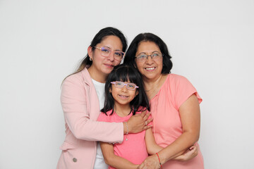 Three generations of brunette Latina women, grandmother, mom and daughter with glasses show their love and family support celebrate Mother's Day