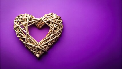 Fototapeta premium Wicker valentine heart on purple background with st valentine's day copy space