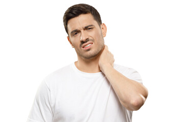 Young handsome man in white t-shirt, touching his neck because it hurts after long working hours, feeling exhausted and worried