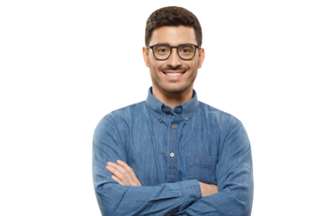 Young businessman wearing casual blue denim shirt and glasses, standing with arms crossed, smiling happily and feeling confident