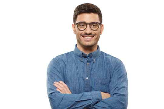 Young businessman wearing casual blue denim shirt and glasses, standing with arms crossed, smiling happily and feeling confident