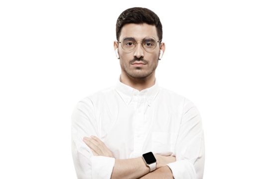 Young handsome man wearing white shirt, glasses, smartwatch and wireless earphones, standing with arms crossed