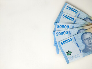 Close up Fifty thousand Indonesian banknotes (Rupiah). Cash payment concept. Indonesian rupiah currency (Rp. 50,000 Fifty Thousand Rupiah) on a white background