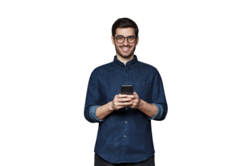 Smiiling modern businessman in denim shirt and trendy glasses holding his phone with both hands