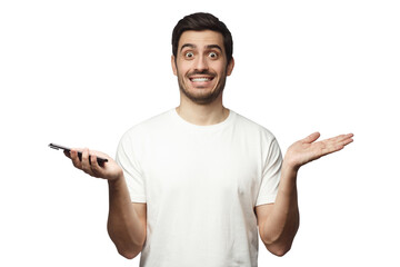 Young man spreading arms while holding phone as if not knowing what to do or surprised