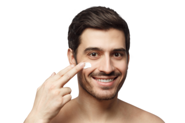 Young handsome man applying face cream to skin