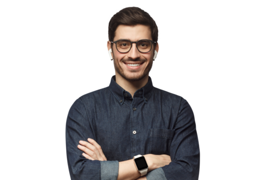 Smiling handsome man in blue denim shirt standing with crossed arms with smartwatch on wrist and earphones