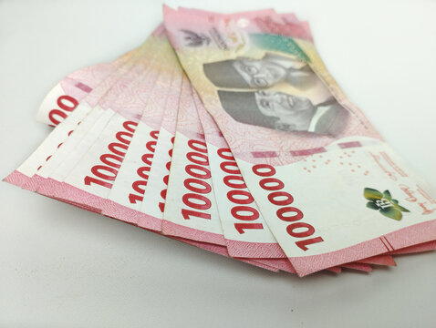Close up One Hundred thousand Indonesian banknotes (Rupiah). Cash payment concept. Indonesian rupiah currency (Rp. 100,000 One Hundred Thousand Rupiah) on a white background