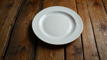 empty porcelain plate centered on wood table wide angle background