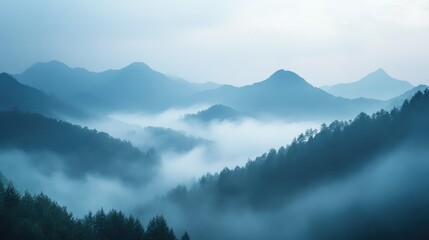 Obraz premium A misty morning view of a mountain range shrouded in fog, capturing the mystery and beauty of the landscape with ample copy space.