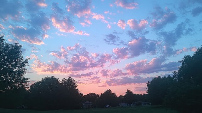 A peaceful evening sky with transparent clouds barely visible as they drift across the fading light.