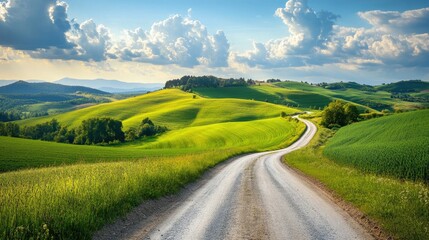 A picturesque road leading through rolling hills and fields, ideal for showcasing the adventure of a road trip. Plenty of space for messages.