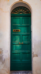 Jade green door with cream bricks