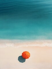 Obraz premium Serene Aerial View of Lone Beach Umbrella on Tranquil Summer Shoreline
