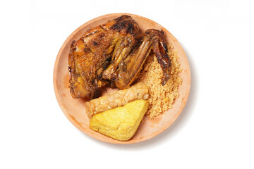 A plate of savory dishes including sweet grilled chicken with a dark brown color, fried tofu and tempeh, and crispy crumbs, served on a wooden plate against a white background.
