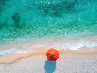 Obraz premium Aerial View of Vibrant Red Umbrella on Breathtaking Summer Beach