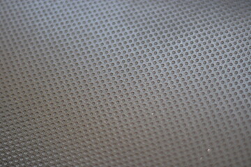 Close-up of a grey textured surface with circular patterns.